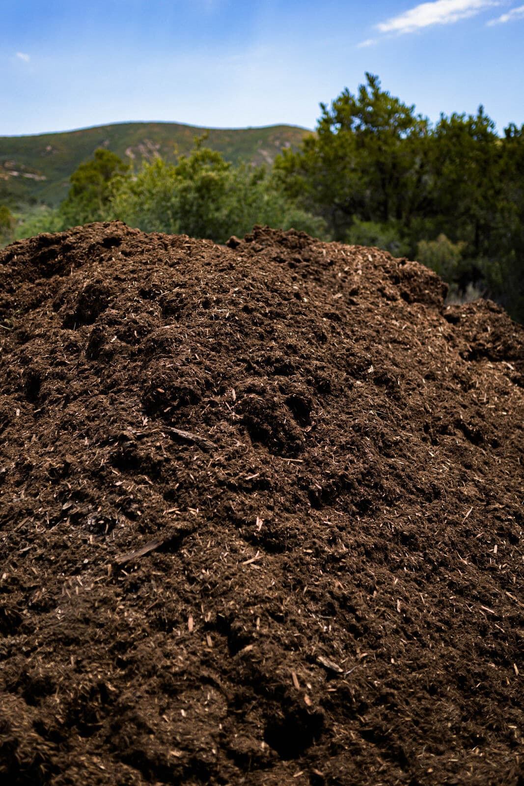Bulk Western Red Cedar mulch pile in the LandEx Earthworks yard for landscape projects in Durango, Colorado