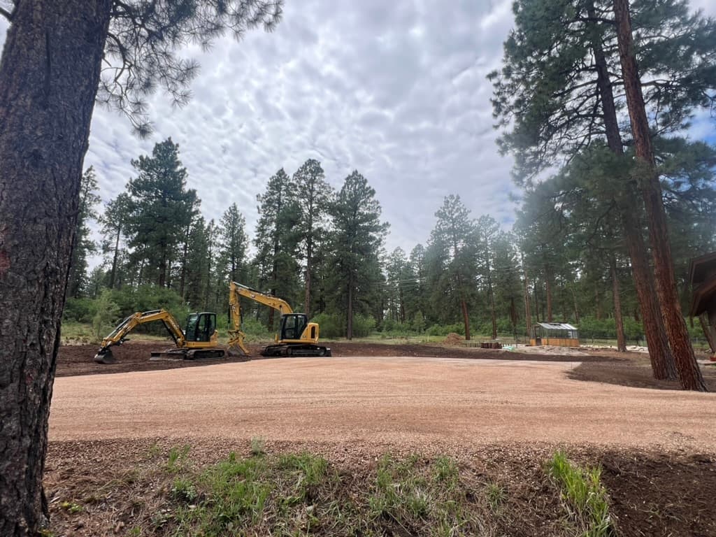 Precision grading with two CAT excavators on a finished building pad in Durango, Colorado