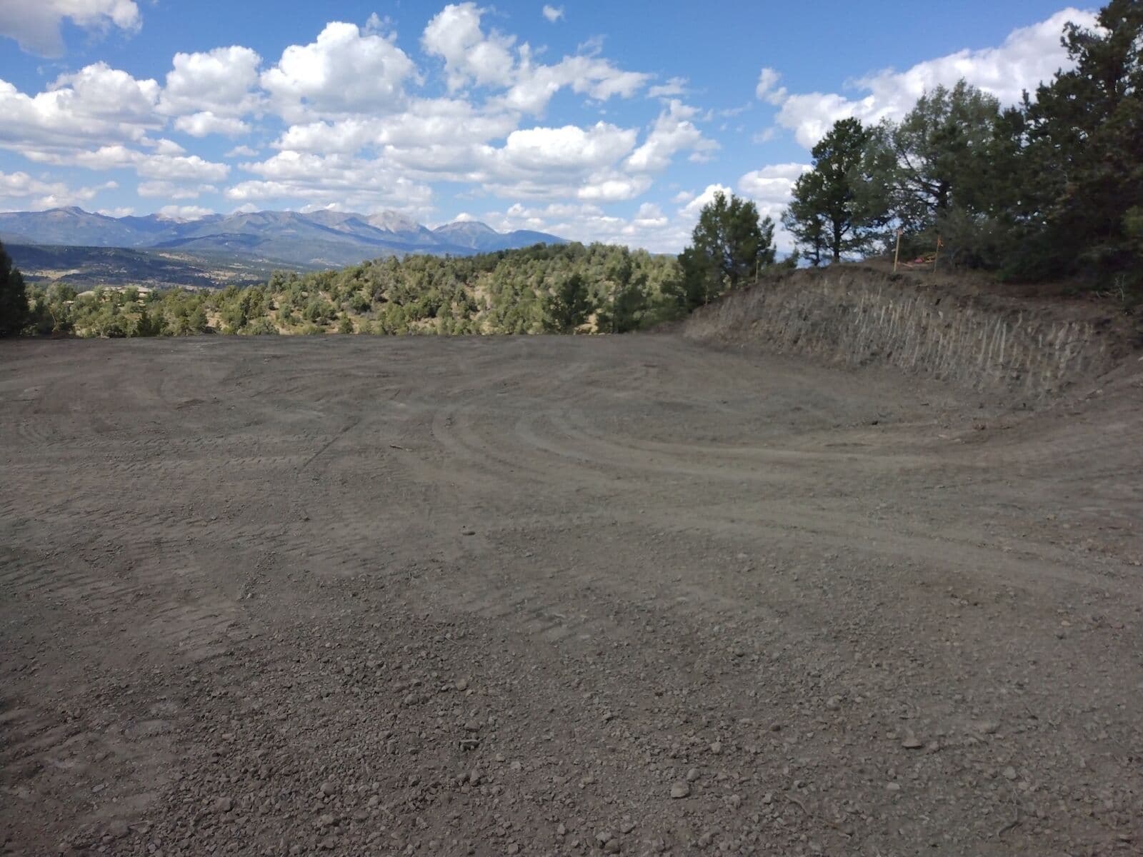 Precision grading of a building pad with mountain views near Durango