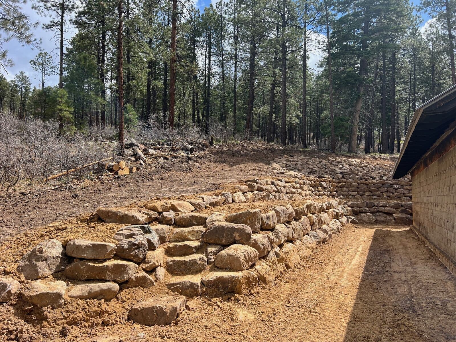 Terraced boulder retaining wall on a hillside in Durango, Colorado